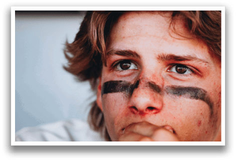 A man with a black and white face mask is sitting down. AI generated content
