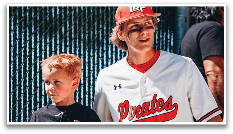 A young boy and a man are standing next to each other. The man is wearing a baseball uniform and a red hat. AI generated content