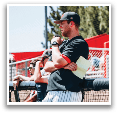A man wearing a black shirt and a cap is sitting on a bench with a baseball bat. AI generated content
