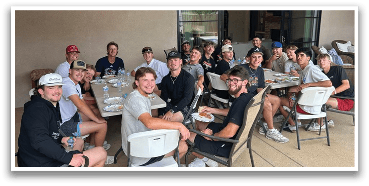 A group of young men and women are sitting around a table, enjoying a meal together. AI generated content