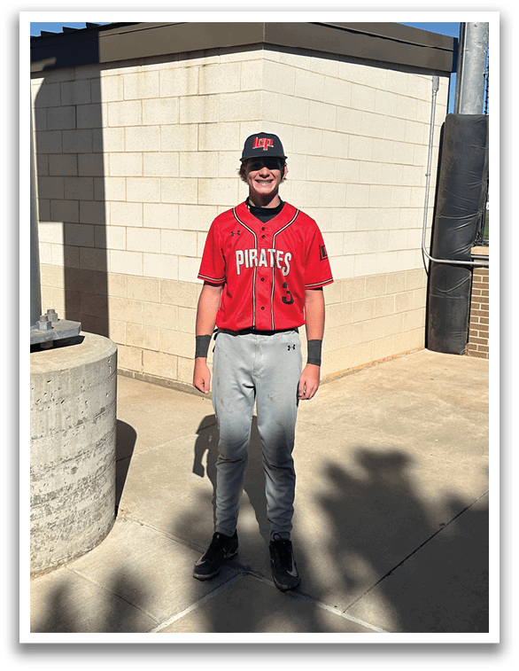 A man wearing a red and black baseball uniform stands in front of a brick wall. AI generated content
