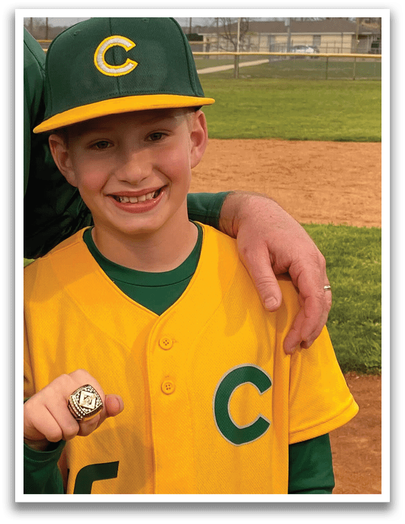 A young boy wearing a baseball uniform and holding a ring. AI generated content
