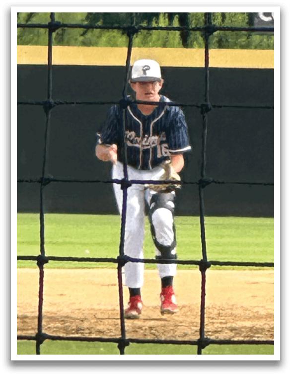 A baseball player in a blue and white uniform is standing on a field, holding a bat and getting ready to hit the ball. AI generated content