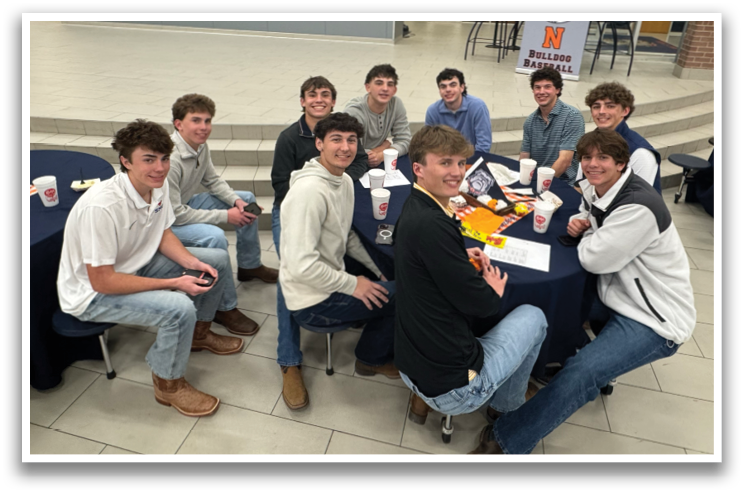A group of young men are sitting around a table in a room. Contenido generado con IA