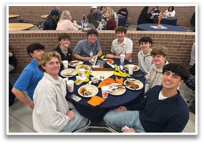 A group of young men and women are sitting around a table, enjoying a meal together. Contenido generado con IA