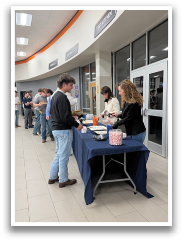 A group of people are standing around a table in a room. Contenido generado con IA