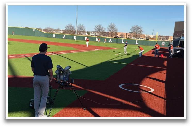 A baseball game is taking place on a field with a man holding a camera. Contenido generado con IA