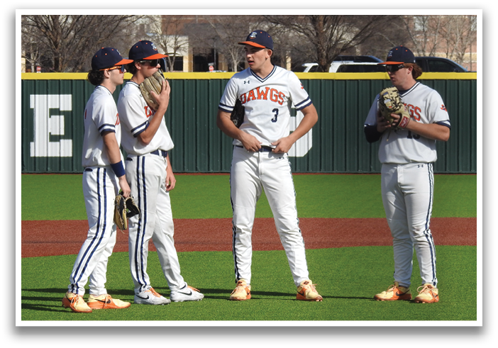 Four baseball players standing on a field, wearing uniforms and holding gloves. Contenido generado con IA
