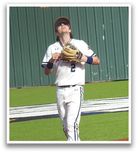 A baseball player is standing on the field with his glove up, ready to catch the ball. Contenido generado con IA