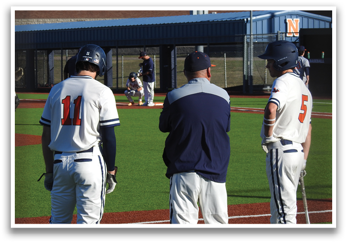 Three baseball players standing on a field, one of them wearing a blue shirt. Contenido generado con IA