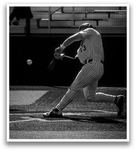 A baseball player is swinging a bat at a ball. Contenido generado con IA
