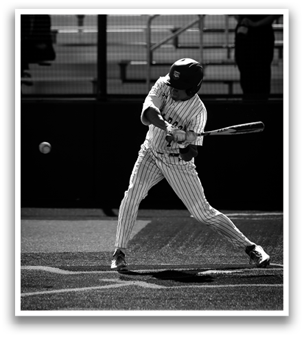 A baseball player is swinging a bat at a ball. Contenido generado con IA