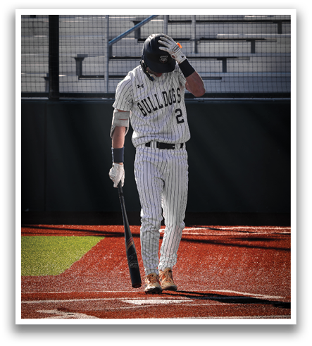 A baseball player is walking off the field with his bat, wearing a helmet. Contenido generado con IA