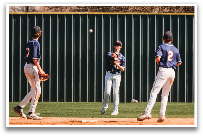 Three baseball players are on the field, one of them is catching a ball. Contenido generado con IA