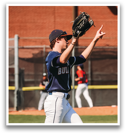 A baseball player in a blue and white uniform is holding up his glove. Contenido generado con IA