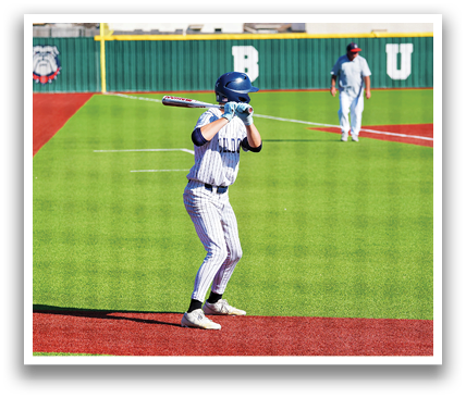 A baseball player is at bat, holding a bat and preparing to swing. Contenido generado con IA