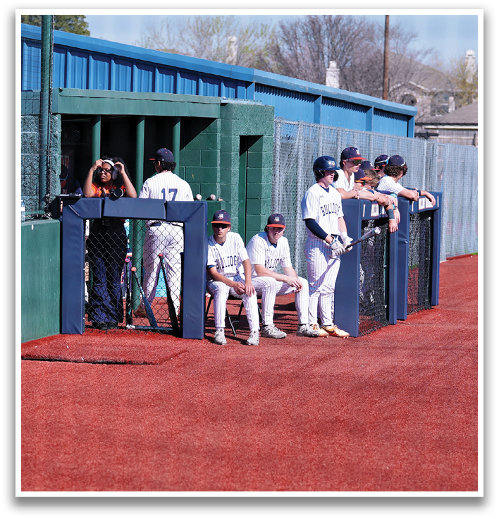 A baseball player stands on a field, holding a bat, and waiting for his turn to bat. Contenido generado con IA
