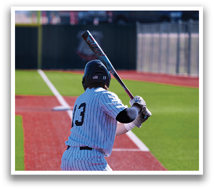 A baseball player is at bat, holding a bat and preparing to swing. Contenido generado con IA