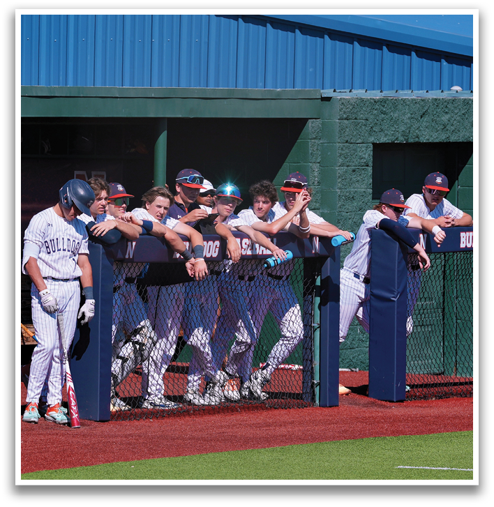A group of baseball players are sitting on a bench, watching the game. Contenido generado con IA