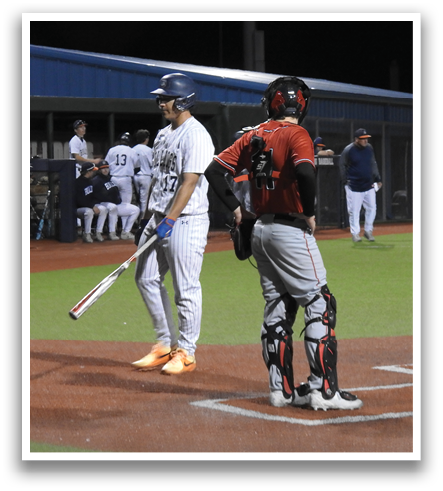 Two baseball players on the field, one holding a bat and the other holding a glove. Contenido generado con IA
