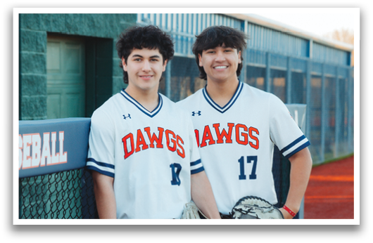 Two young men wearing baseball uniforms and holding baseball gloves. Contenido generado con IA