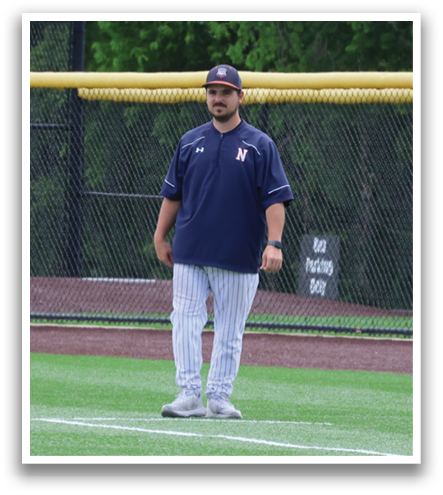 A baseball player stands on the field, wearing a blue shirt and a blue hat. Contenido generado con IA