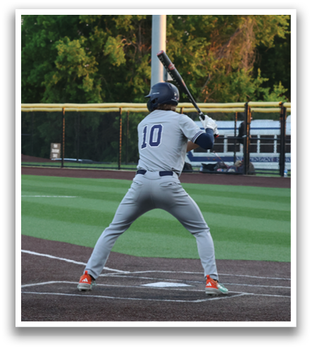 A baseball player is at bat, holding a bat and preparing to swing. Contenido generado con IA