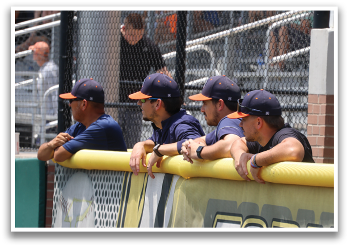 Baseball players sitting on a fence, watching the game. Contenido generado con IA