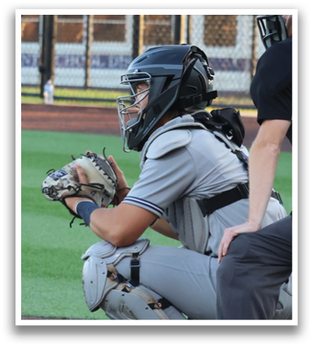 A baseball game is in progress with a batter, catcher, and umpire. The batter is holding a bat and preparing to swing. The catcher is wearing a baseball glove, ready to catch the ball. The umpire is standing behind the catcher, closely observing the play. Contenido generado con IA