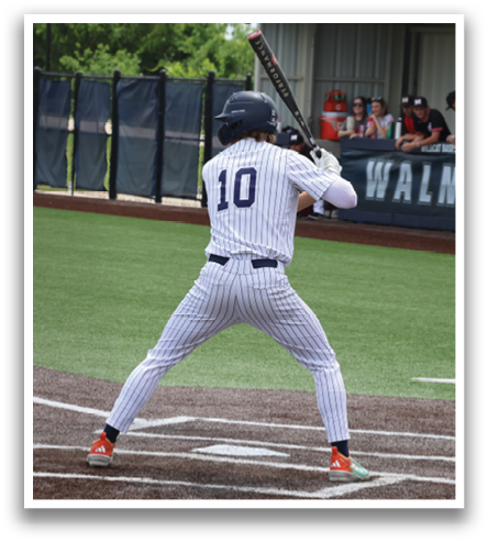 A baseball player is at bat, holding a bat and preparing to swing. Contenido generado con IA