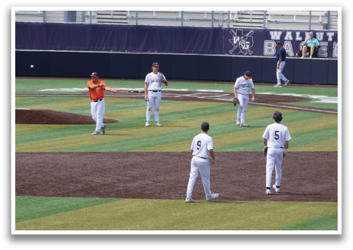 A group of baseball players are standing on a field, with one player holding a baseball bat. Contenido generado con IA