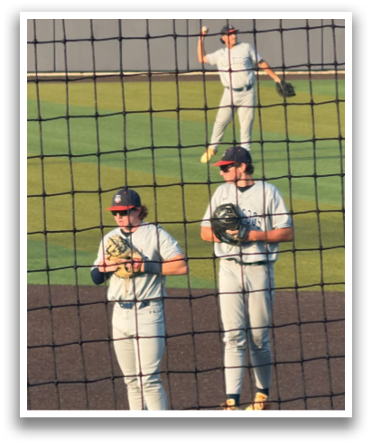 Two baseball players wearing grey uniforms and holding baseball gloves. Contenido generado con IA