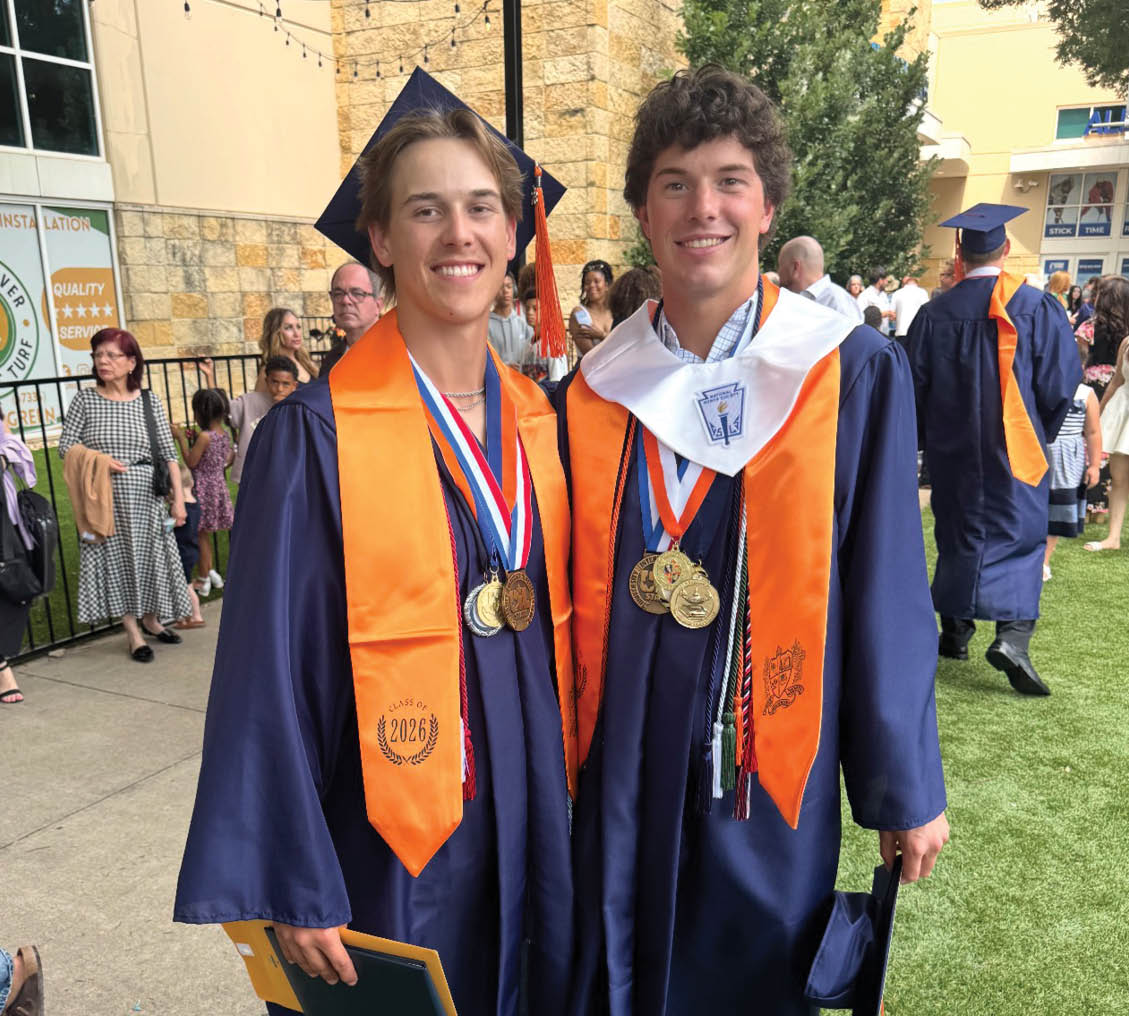 Two young men in blue graduation robes and gold medals pose for a photo. Contenido generado con IA