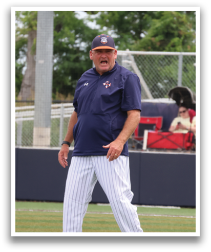 A man wearing a blue shirt and white pants stands on a baseball field. Contenido generado con IA
