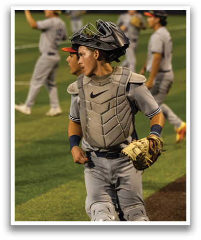 A baseball player wearing a catcher's mitt and a helmet is walking on the field. Contenido generado con IA