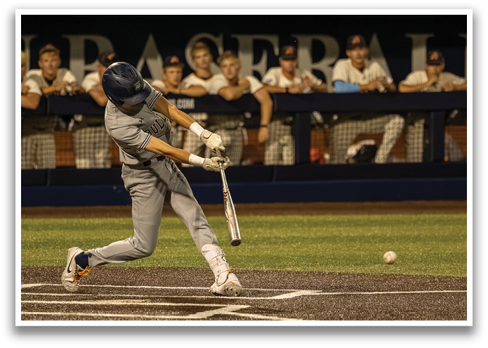 A baseball player is swinging a bat at a ball. Contenido generado con IA
