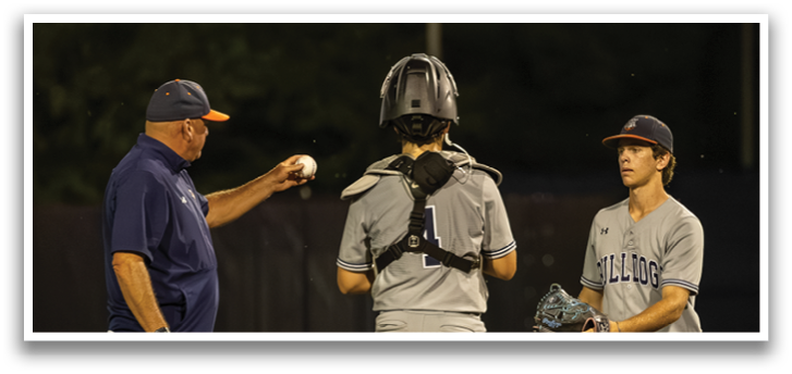 Three baseball players on a field, one of them holding a baseball. Contenido generado con IA