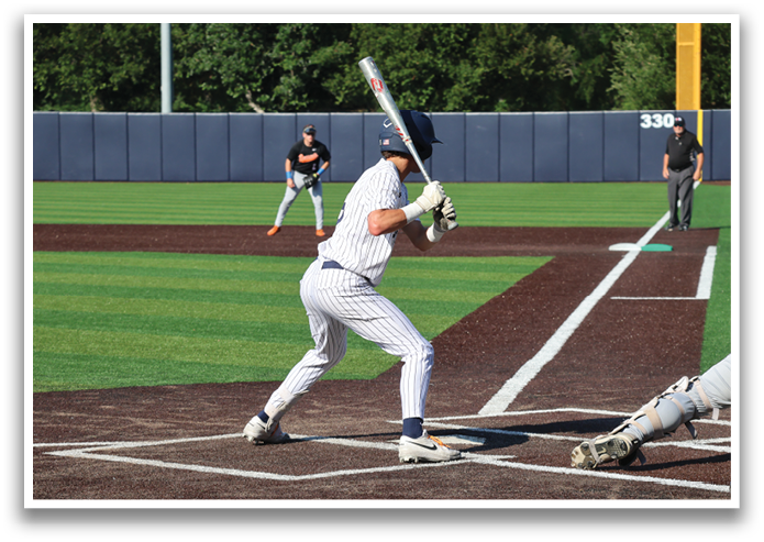 A baseball player is swinging a bat at a ball during a game. Contenido generado con IA