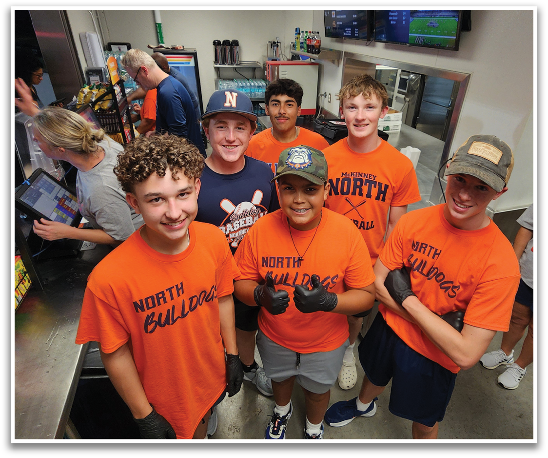A group of five people wearing orange shirts pose for a picture. Contenido generado con IA