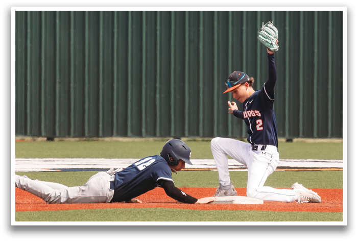 Two baseball players are on the ground, one sliding into a base while the other is trying to catch the ball. Contenido generado con IA