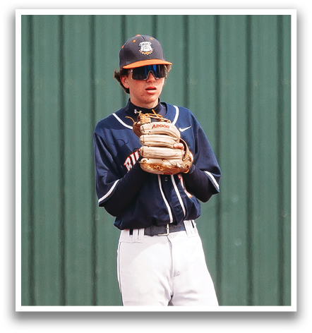 A baseball player wearing a blue and white uniform stands on the field, holding a catcher's mitt. Contenido generado con IA