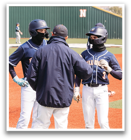 Three baseball players wearing blue and white uniforms are standing on a field. One of the players is wearing a mask. Contenido generado con IA