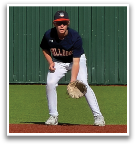 A baseball player in a blue and orange uniform is standing on the field, holding a baseball glove. Contenido generado con IA