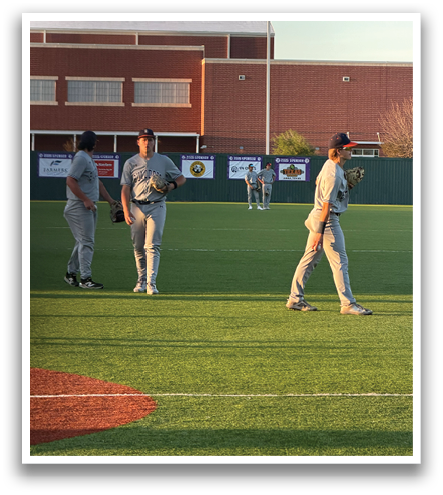 Three baseball players standing on a field, two of them wearing grey uniforms. Contenido generado con IA