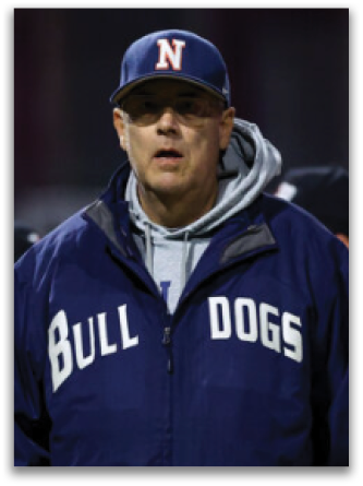 A man wearing a blue jacket with the word Bulldogs on it. Contenido generado con IA
