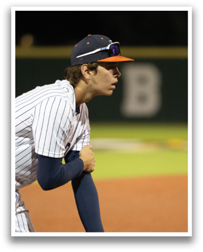A baseball player wearing a blue shirt and a black hat is holding a baseball glove. Contenido generado con IA