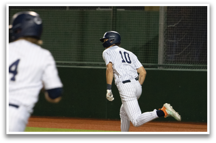 A baseball player is running to first base while another player is running to second base. Contenido generado con IA