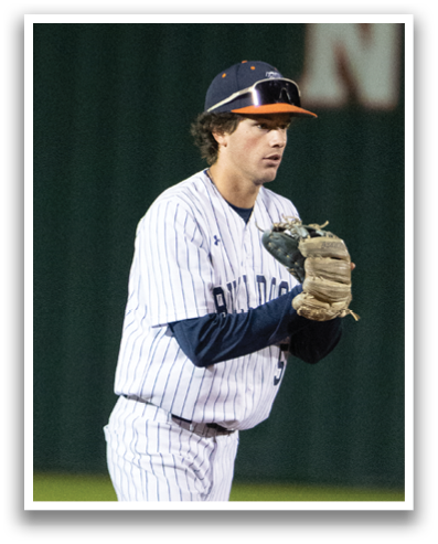 A baseball player in a white and blue uniform is standing on the field, holding a baseball glove. Contenido generado con IA