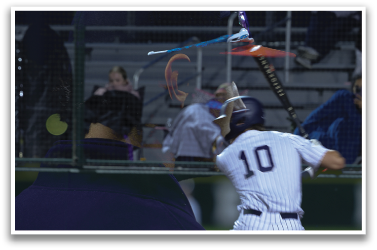 A baseball player is swinging a bat at a ball. Contenido generado con IA