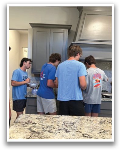 A group of people are gathered in a kitchen, preparing food. Contenido generado con IA